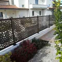 Modern metal fence with geometric cutouts, offering privacy and style. Perfect for **ideas ocultación jardin** and creating a chic outdoor space.