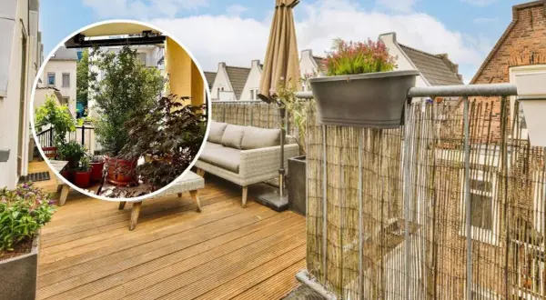 Disfruta de la intimidad en esta terraza ático con muebles cómodos y vegetación exuberante.